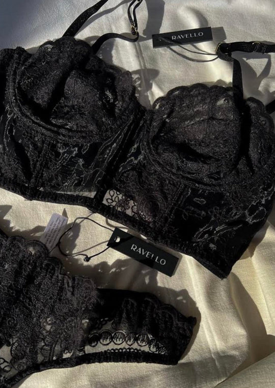 Black lace lingerie set with 'Ravello' tags on a light background