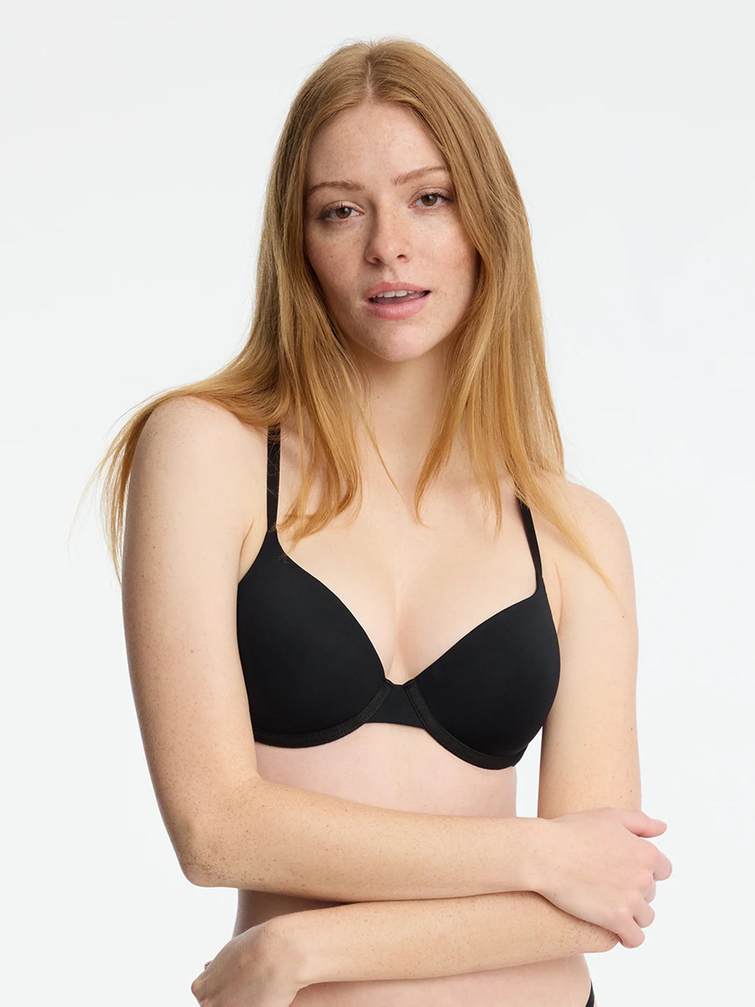 Model wearing the Insider Convertible T-Shirt Bra in black, featuring flex fit foam cups for comfort and support.