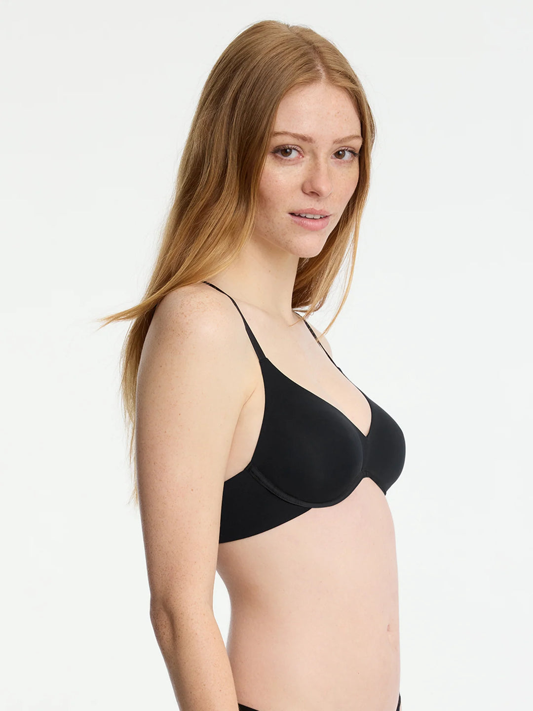 Model wearing Insider Seamless Underwire Bra in black, showcasing its ultra-stretch matte jersey and molded cups for comfort.