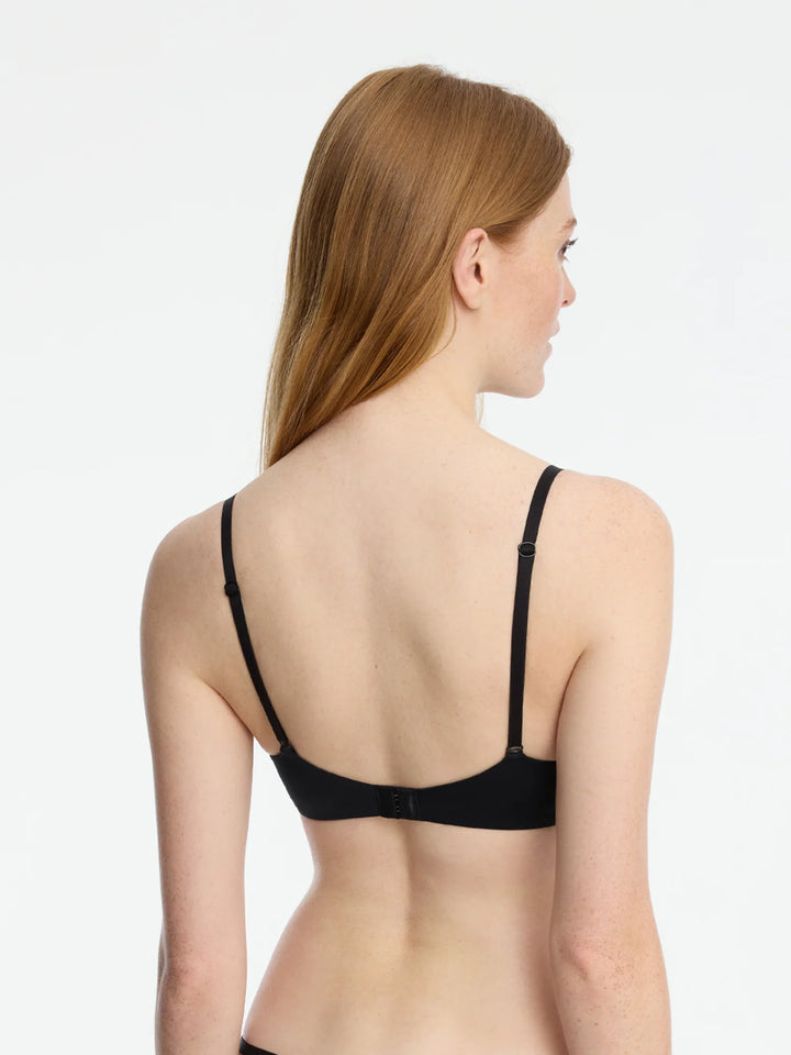 Back view of a woman wearing the Insider Seamless Underwire Bra, showcasing its sleek design and adjustable straps.