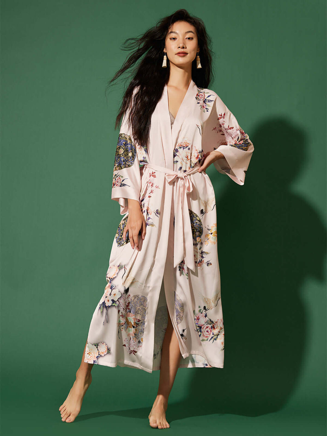 Model wearing the Garden Crane Blush Kimono Robe, featuring hand-painted floral prints and a luxurious design.