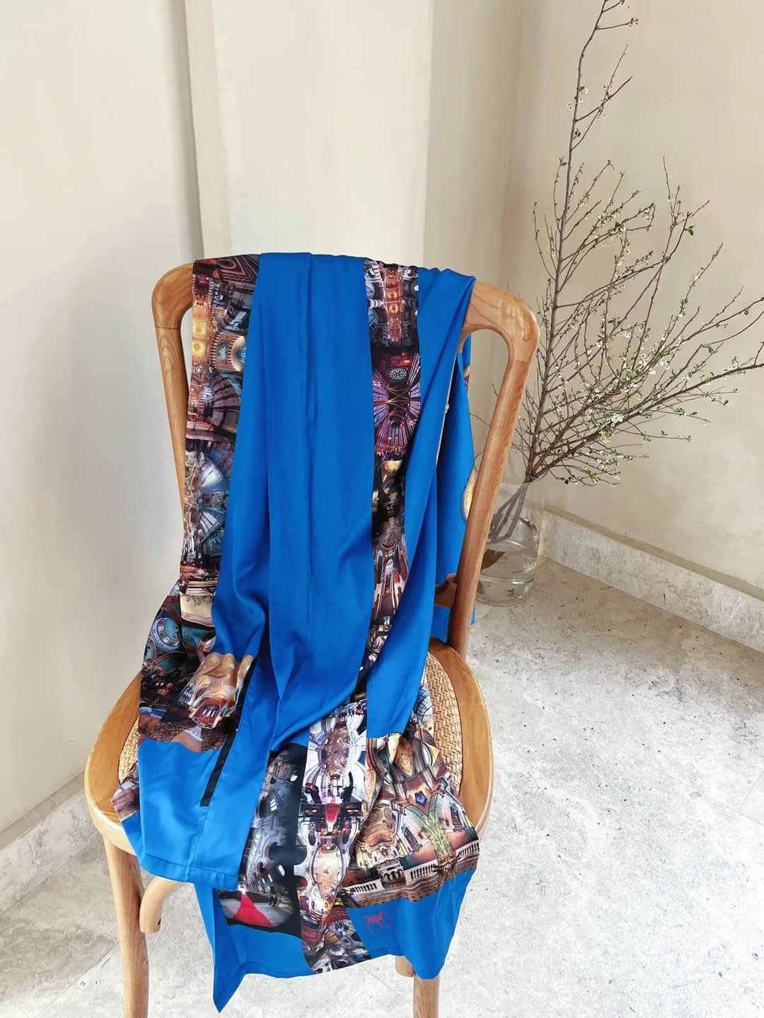 Paris Cathedral Kimono Robe elegantly draped over a wooden chair, showcasing intricate design and luxurious silk feel.