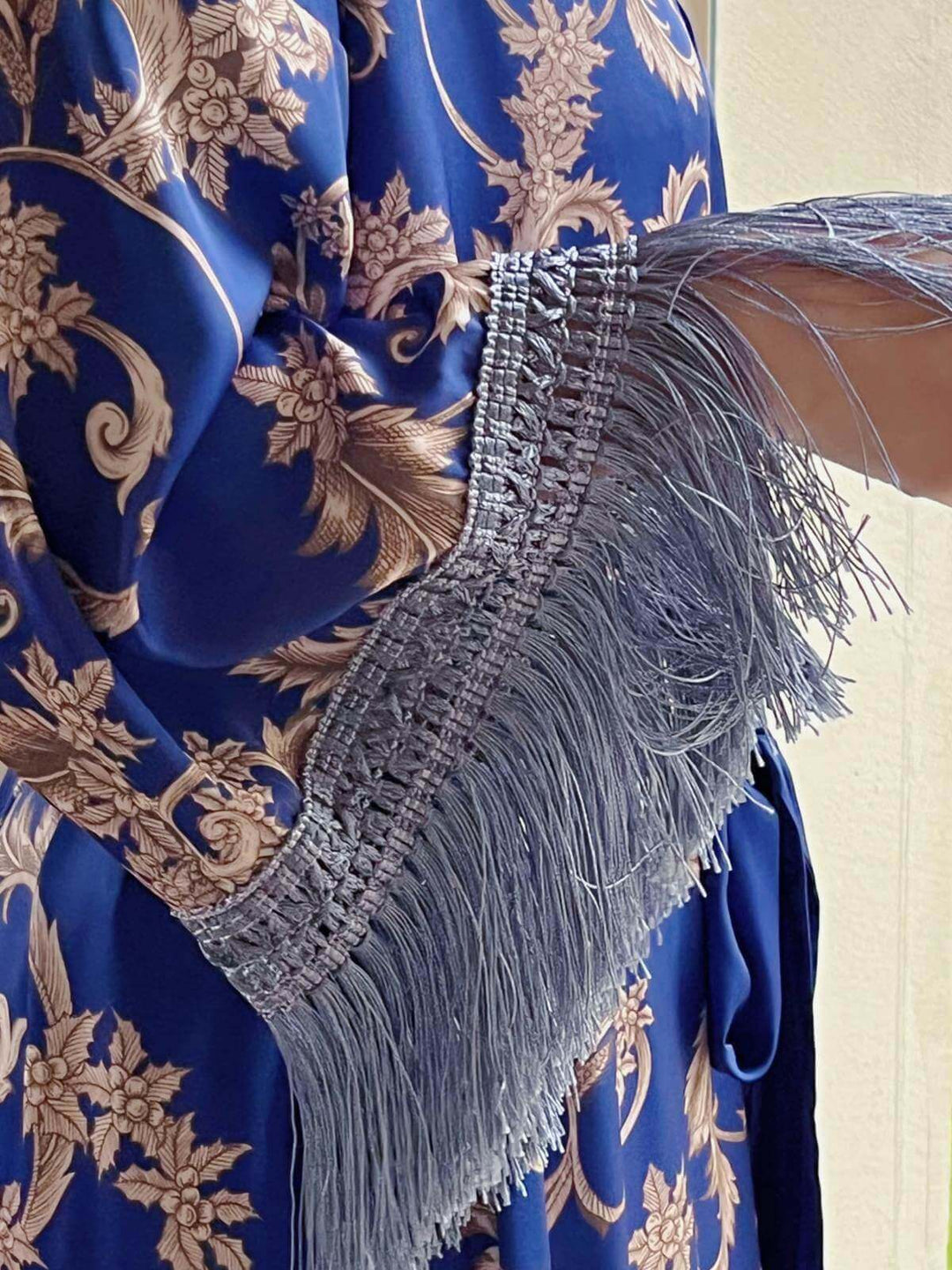Close-up of tassels on the sleeve of a Tassels Blue Kimono Robe, showcasing luxurious design and details.