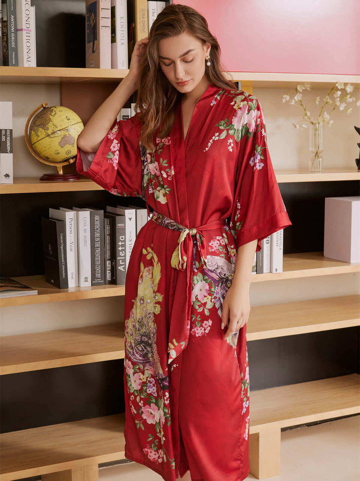 Model in a Peacock Red Kimono Robe showcasing luxury and comfort with vibrant floral prints.