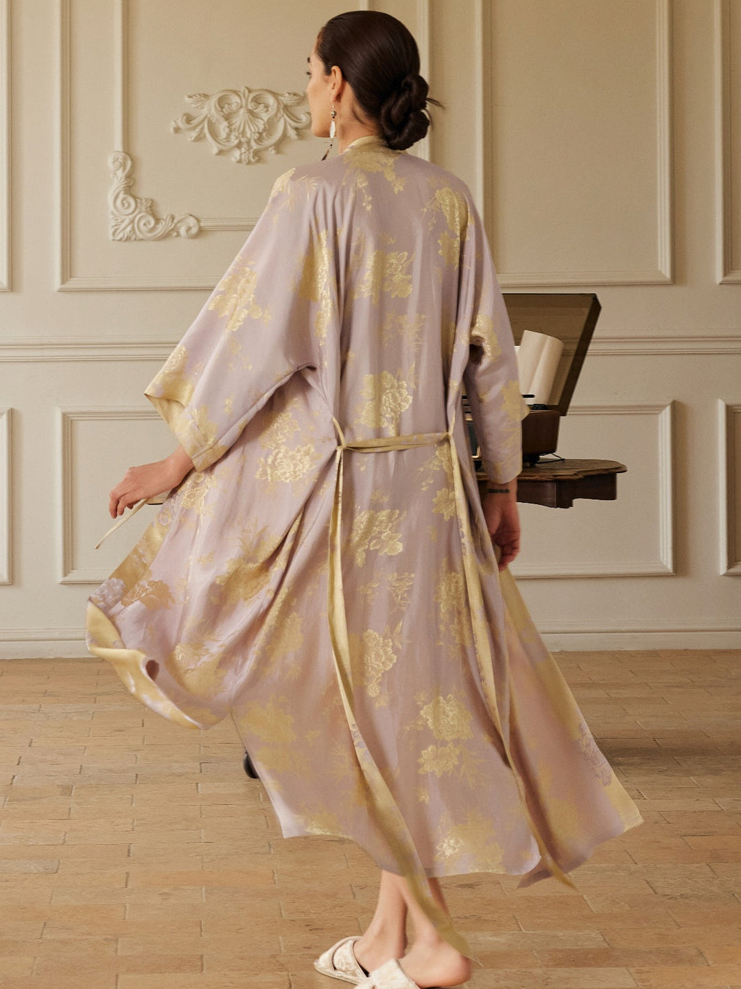 Back view of a model wearing a Reversible Lavender & Gold Jacquard Kimono Robe, showcasing its luxurious design.