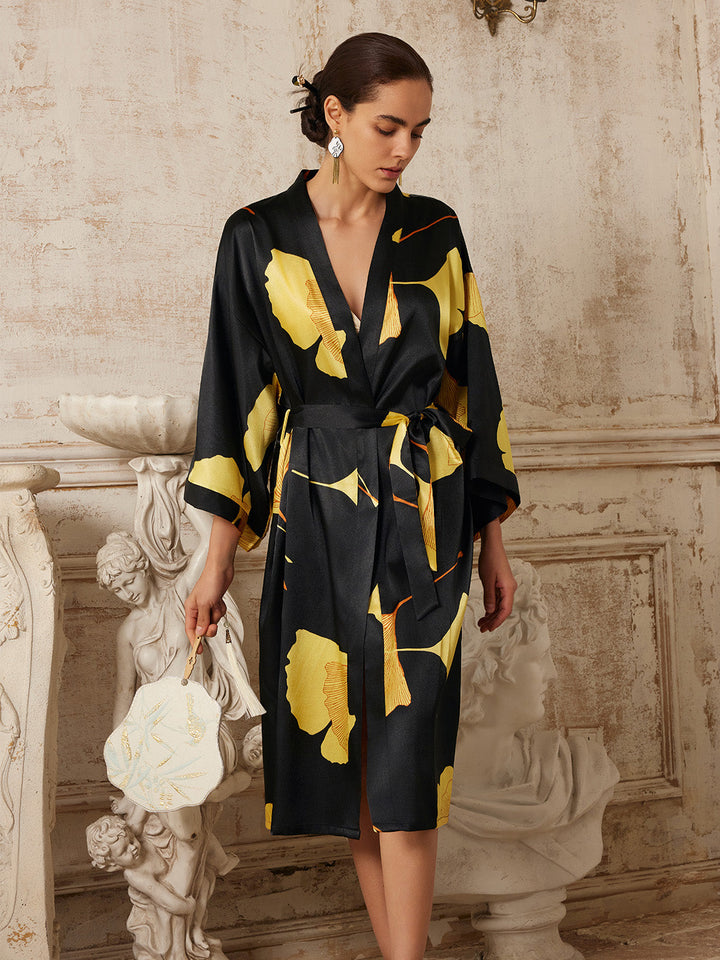 Model wearing Yellow Ginkgo Leaf Print Black Kimono Robe, showcasing luxury and elegance in a vintage setting.