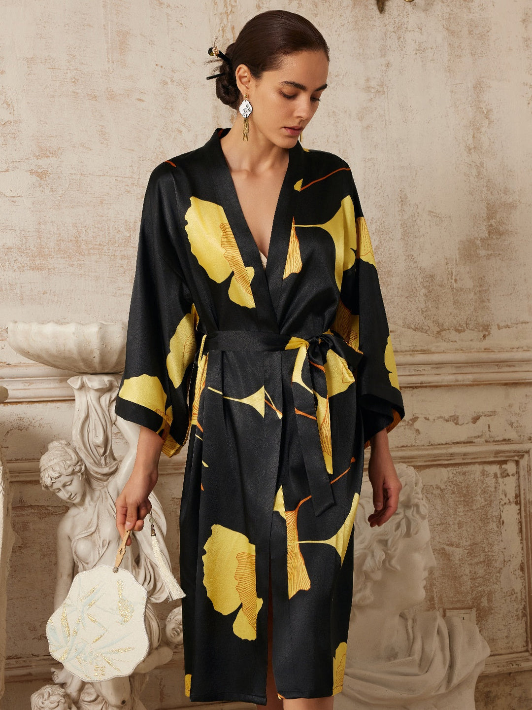 Yellow Ginkgo Leaf Print Black Kimono Robe modeled with elegance against a vintage backdrop.