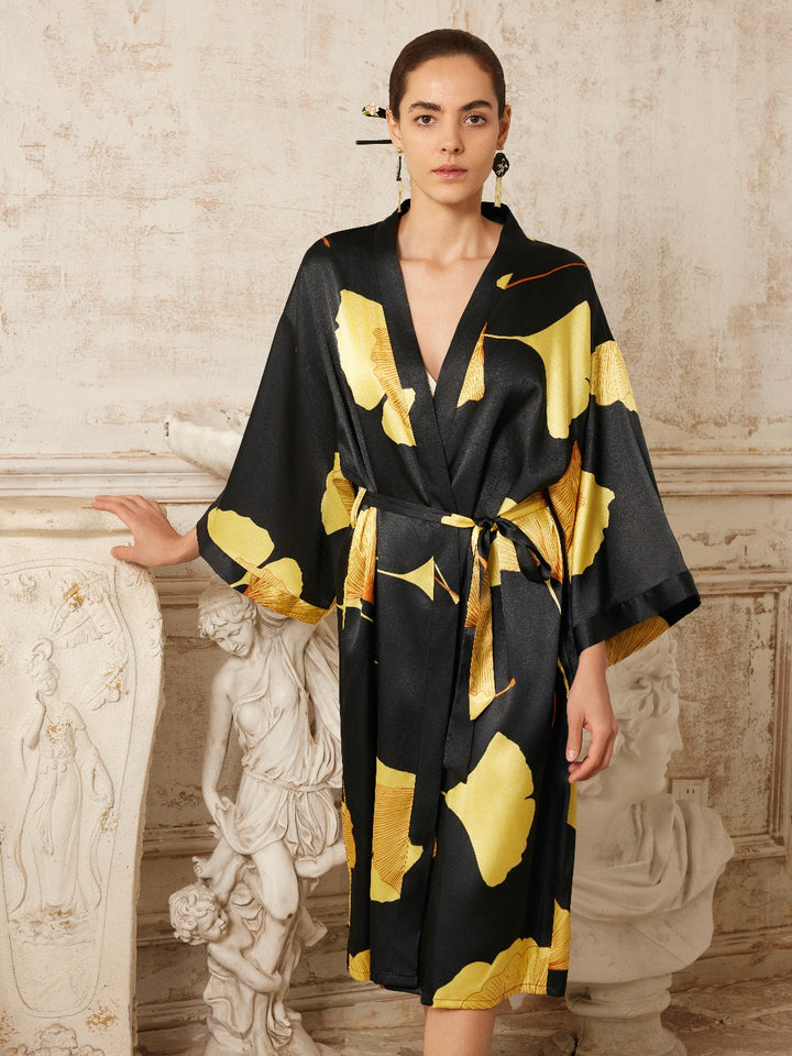 Yellow Ginkgo Leaf Print Black Kimono Robe displayed by a model against a classic backdrop, epitomizing luxury fashion.
