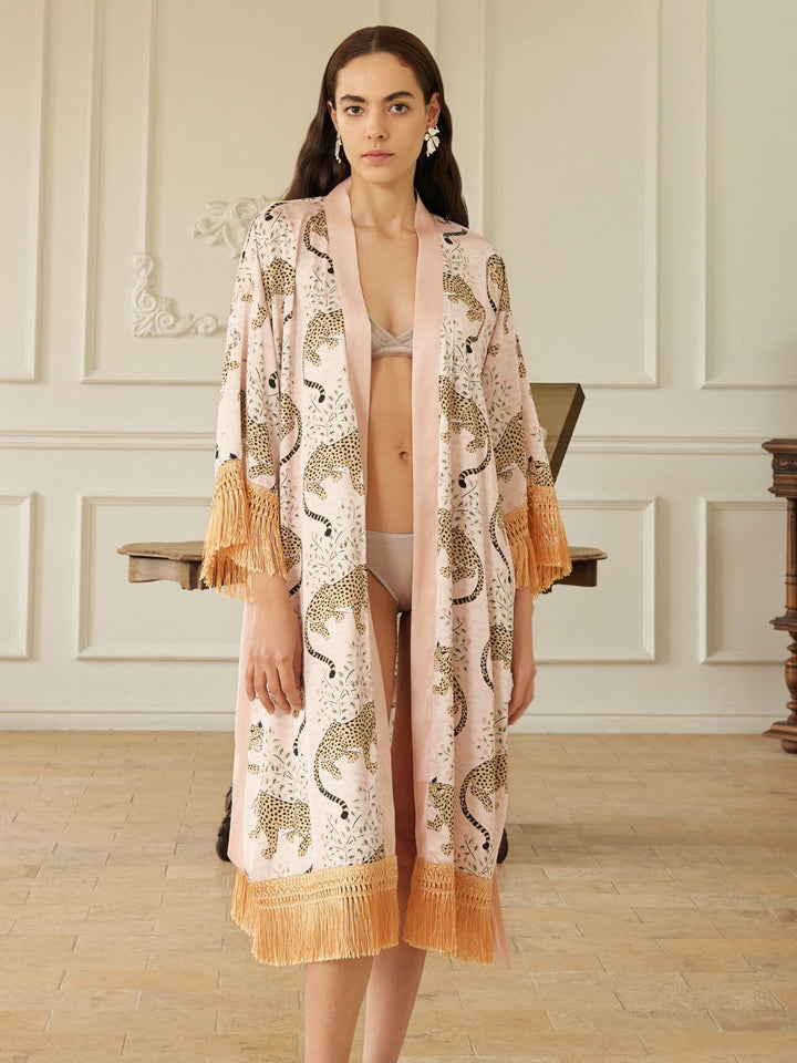 Model wearing a Pink Leopard Tassel Kimono Robe, showcasing its chic pink leopard print and elegant tassels.