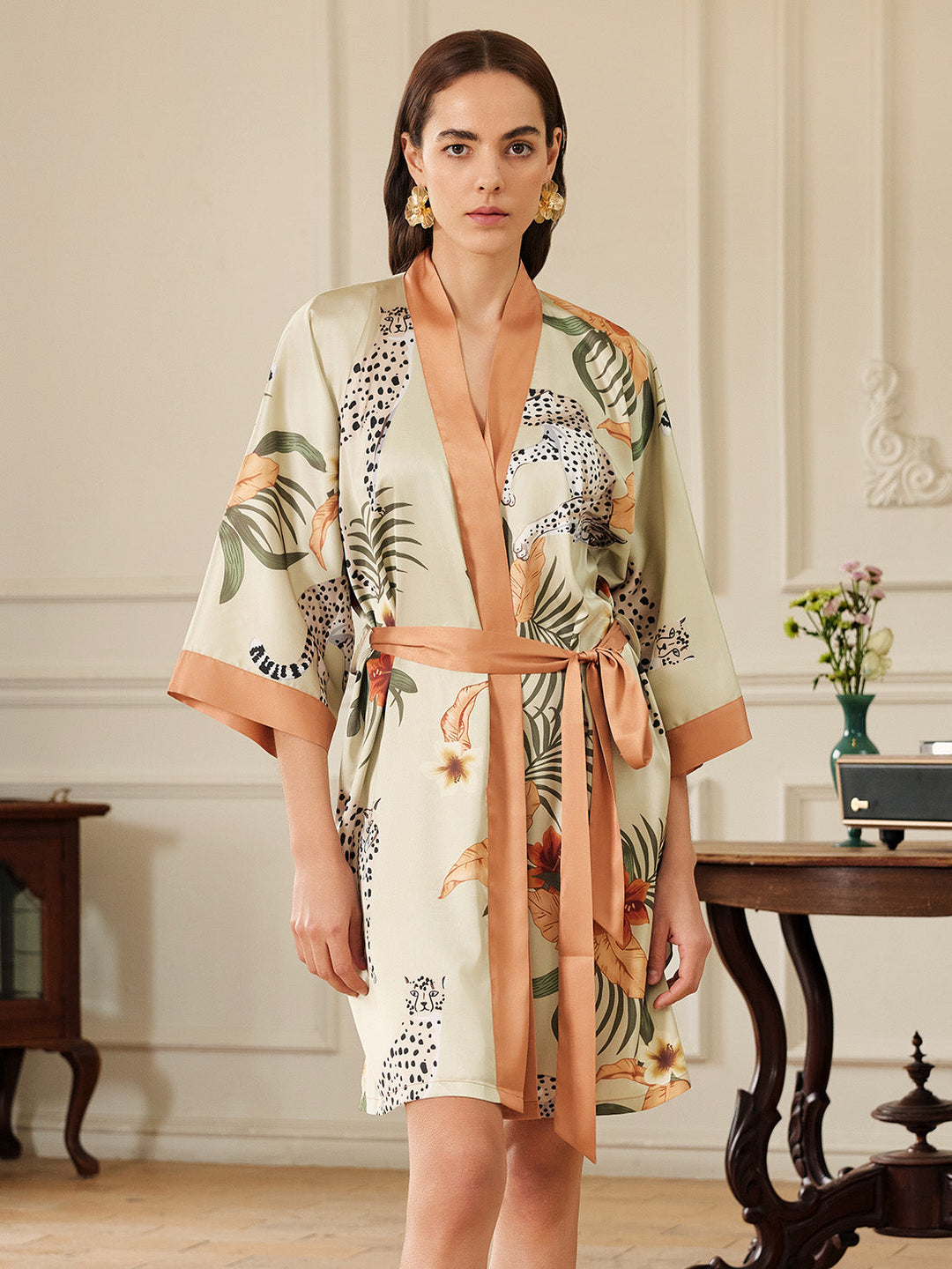 Model wearing an Orange Leopard Short Kimono Robe, showcasing luxury and vibrant floral patterns.