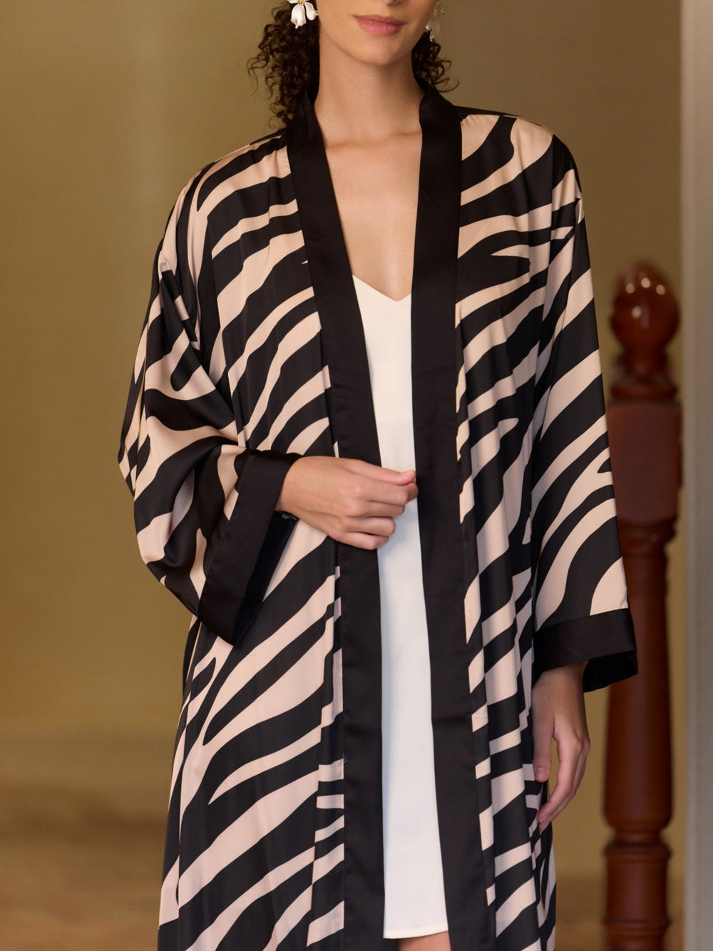 Model wearing a Black Zebra Stripe Kimono Robe showcasing its stylish and bold design in a chic setting.