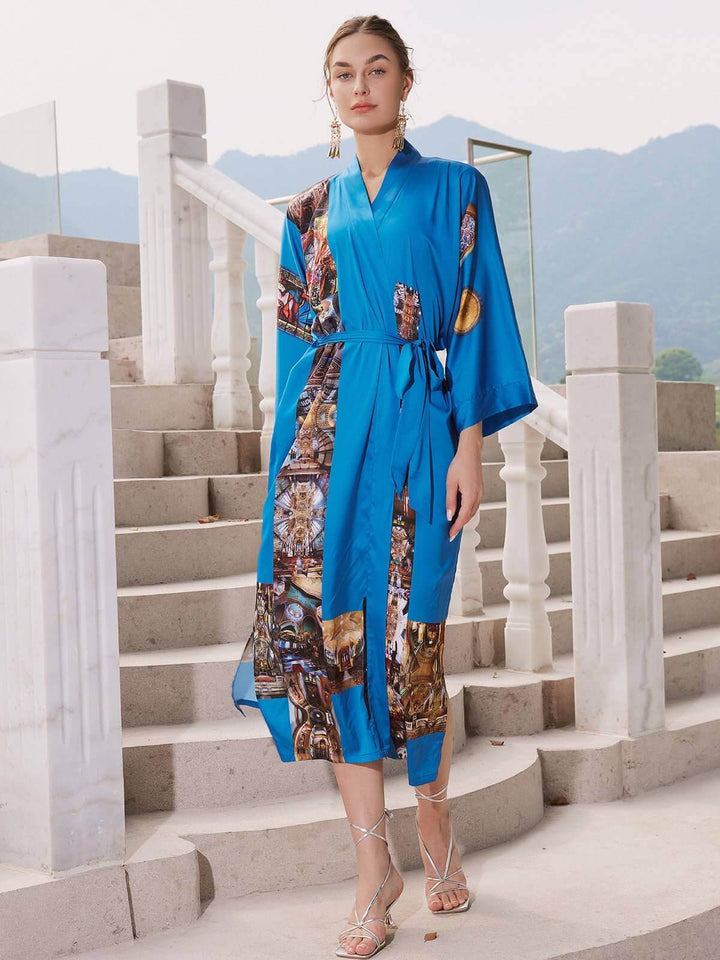 Model wearing a Paris Cathedral Kimono Robe in vibrant blue, showcasing luxurious fabric and stylish design.