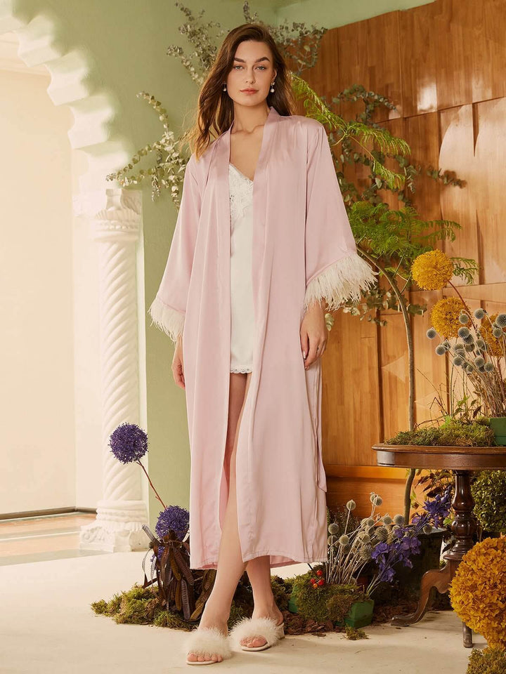 Model wearing a luxurious Pink Feather Bridal Robe with feather details, exuding elegance and style.
