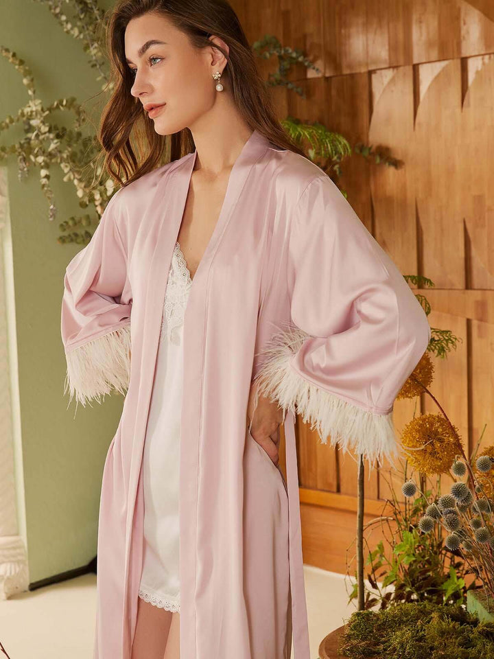 Model wearing a Pink Feather Bridal Robe showcasing luxury and elegance with soft pink fabric and feather details.