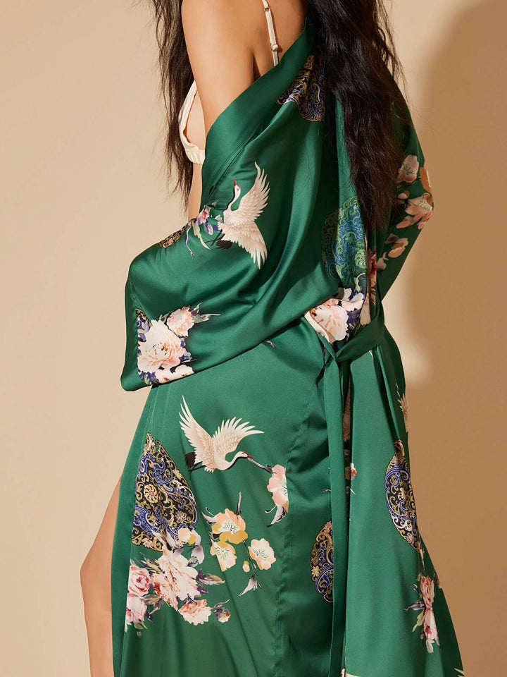 Model wearing a Garden Crane Green Kimono Robe with floral design, showcasing luxury and elegance.