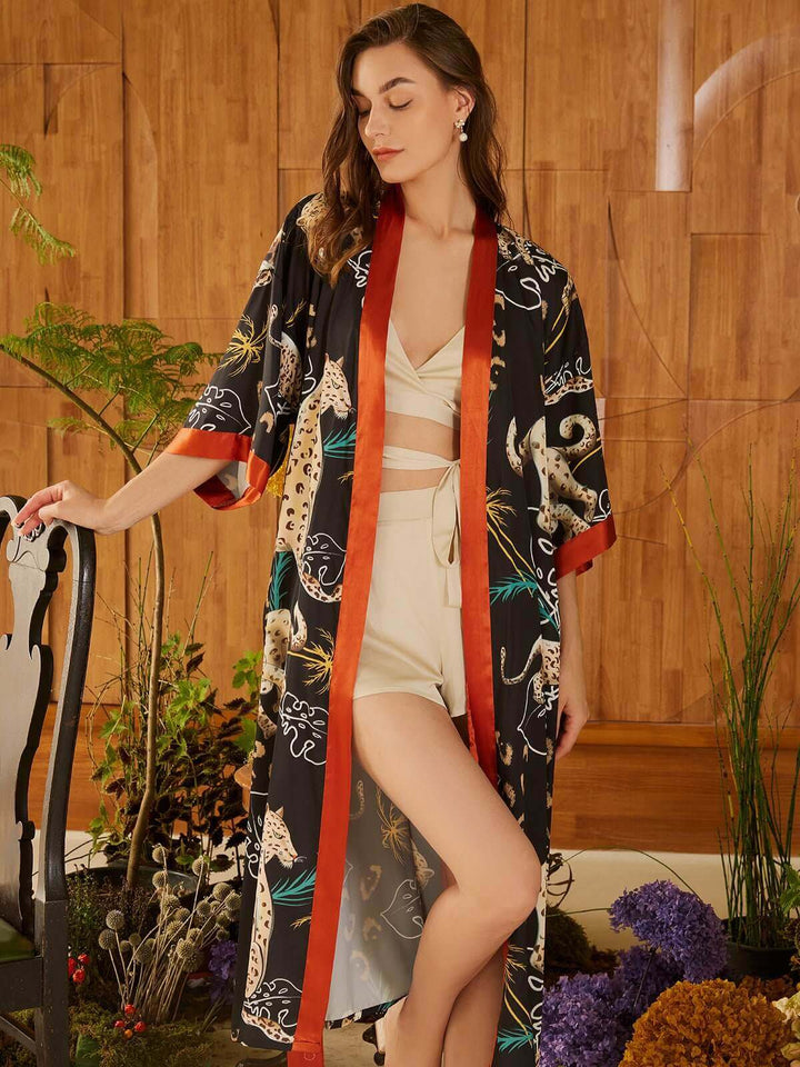 Model wearing a Jungle Animals Kimono Robe with hand-painted jungle animal prints, showcasing luxury and elegance.