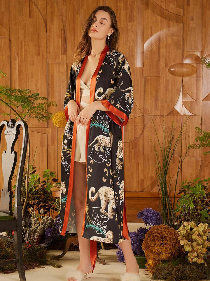 Jungle Animals Kimono Robe showcasing a model in a luxurious robe with hand-painted jungle animals prints.