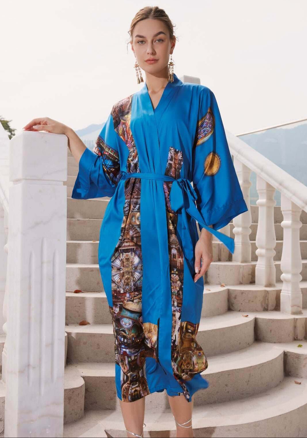 Model wearing a stylish Paris Cathedral Kimono Robe featuring elegant blue color and luxurious design on a stairway.