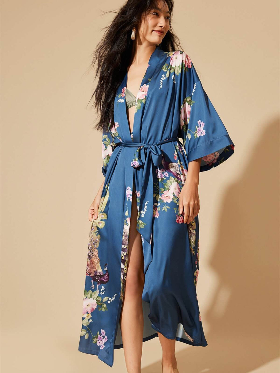 Model wearing a Peacock Blue Kimono Robe with floral prints, showcasing luxury and elegance.