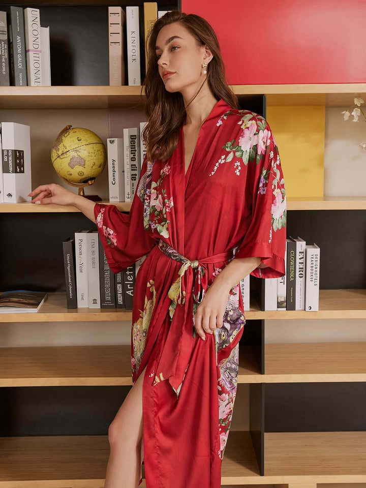 Model wearing a Peacock Red Kimono Robe, showcasing luxury and elegance with vibrant floral designs.