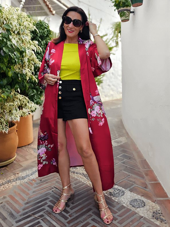 Model showcasing the Peacock Red Kimono Robe with vibrant floral prints, styled elegantly with a chic outfit.
