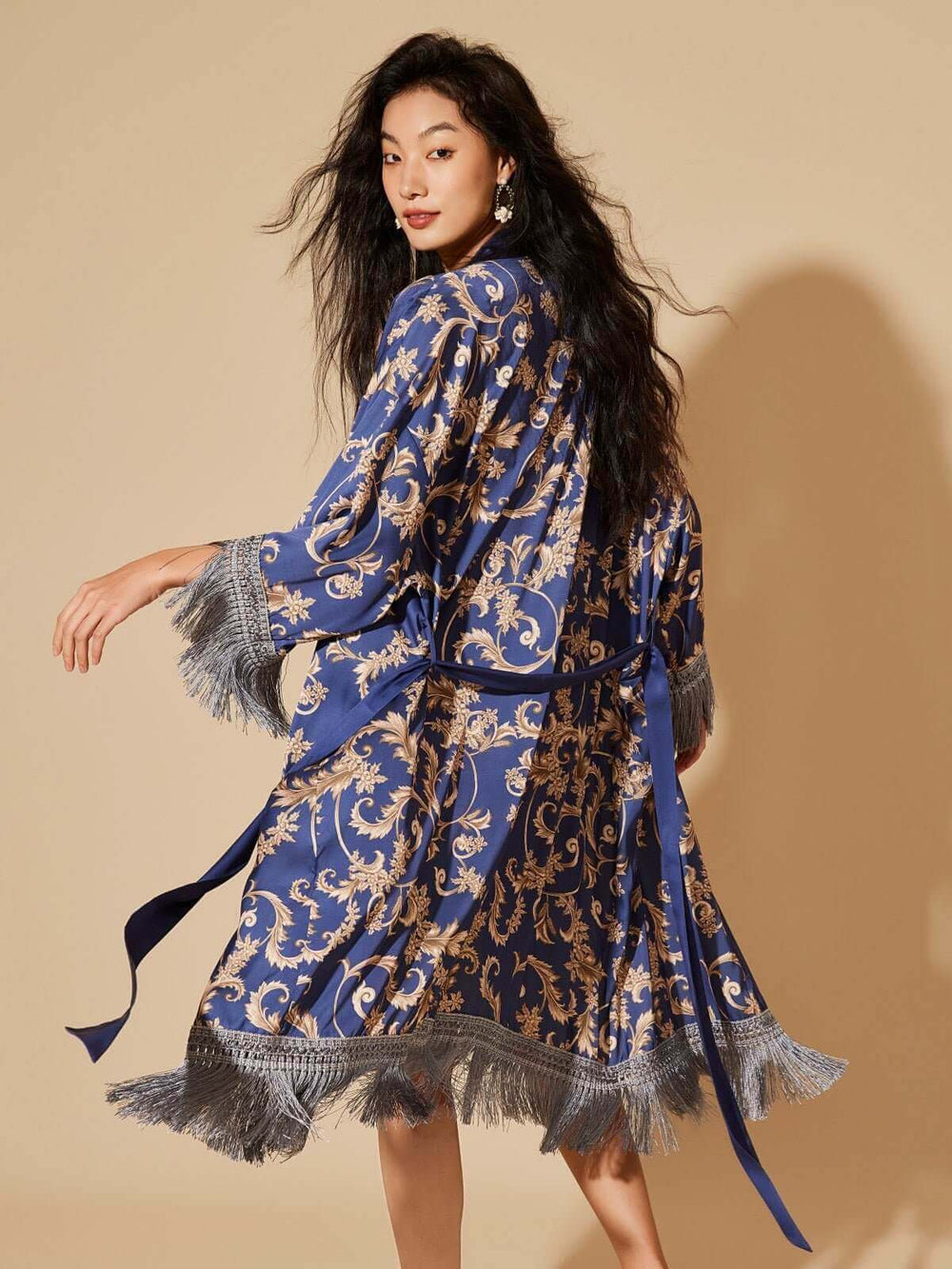 Elegant model showcasing a luxurious Tassels Blue Kimono Robe with intricate designs and detailed tassels.