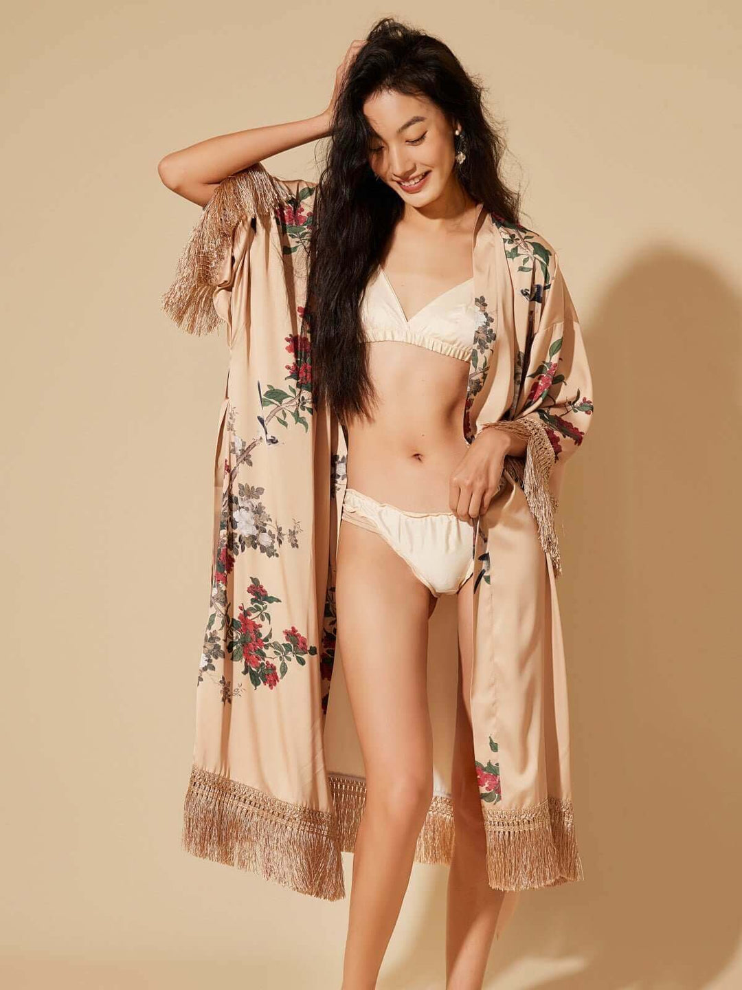 Tassels Champagne Kimono Robe worn by a model, showcasing luxurious floral design and elegant fringes.