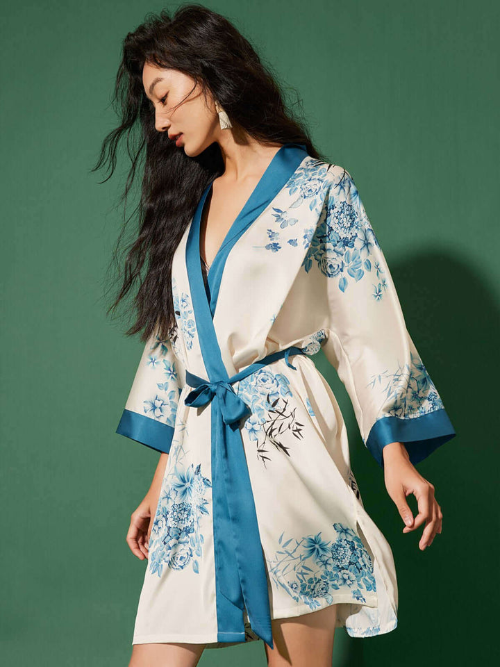 Elegant woman wearing a Short Kimono Robe bamboo with floral design and silky comfort against a green background.