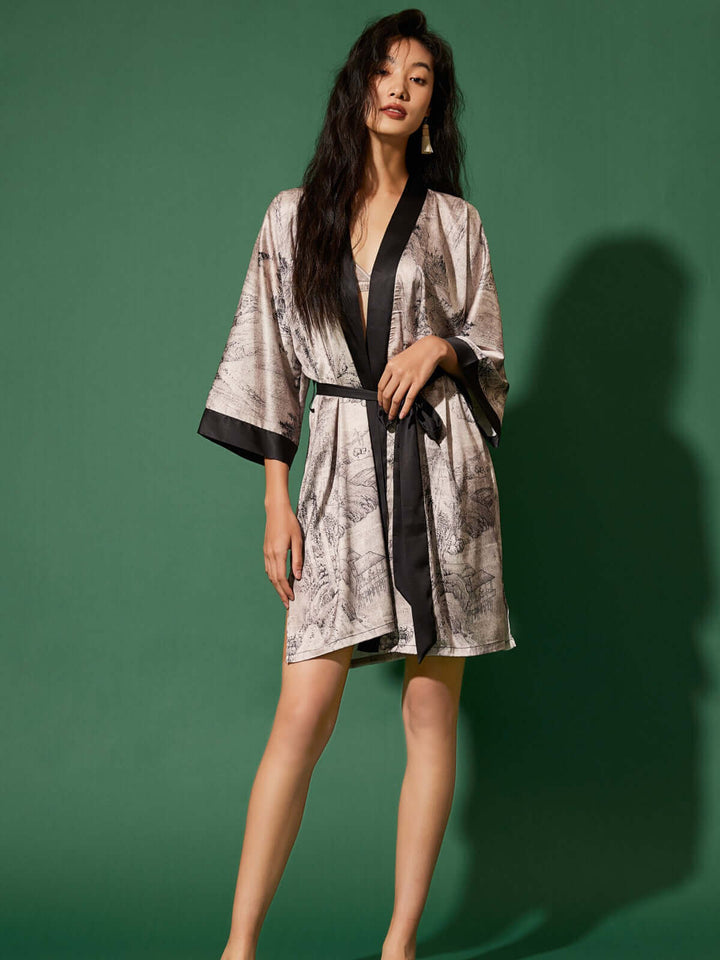 Short Kimono Robe Ink Painting on model, showcasing luxury design and elegance against a green backdrop.