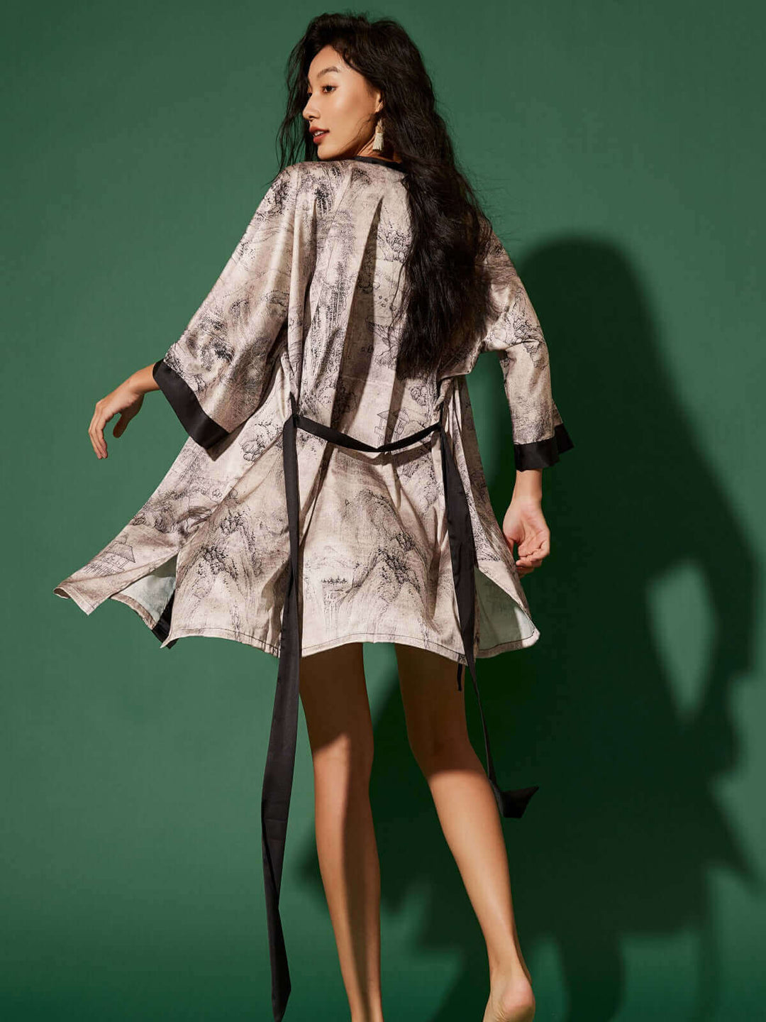 Elegant woman wearing a Short Kimono Robe Ink Painting against a green background, showcasing luxury and comfort.