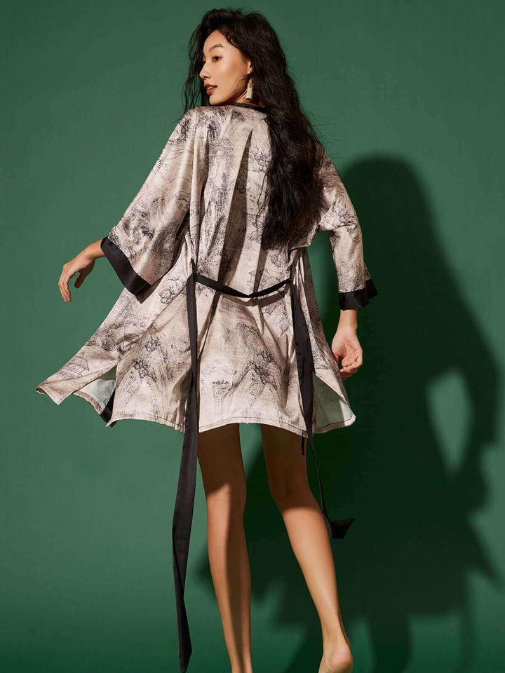 Elegant woman wearing a Short Kimono Robe Ink Painting against a green background, showcasing luxury and comfort.